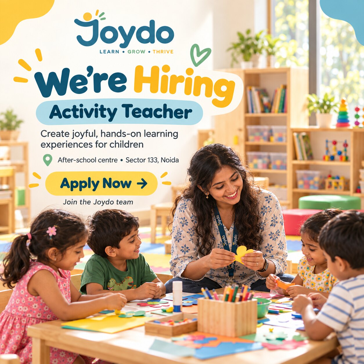Joydo is hiring an Activity Teacher. Create joyful, hands-on learning experiences for children. After-school centre, Sector 133, Noida. An educator sits at a low table with four children, cutting and gluing coloured paper shapes.